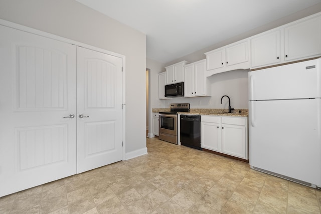 kitchen featuring light stone counters, white cabinetry, black appliances, and a sink