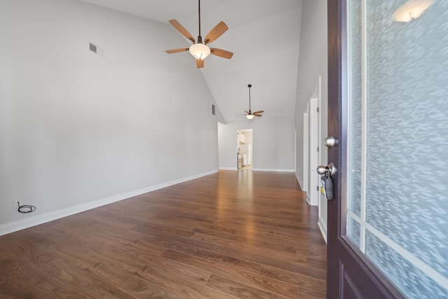 entrance foyer featuring a ceiling fan, baseboards, visible vents, high vaulted ceiling, and dark wood finished floors