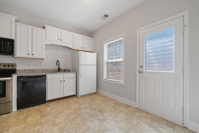 kitchen with black appliances, baseboards, light stone counters, white cabinetry, and a sink