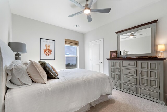 bedroom featuring light carpet and ceiling fan