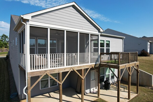 back of house with a patio and a sunroom