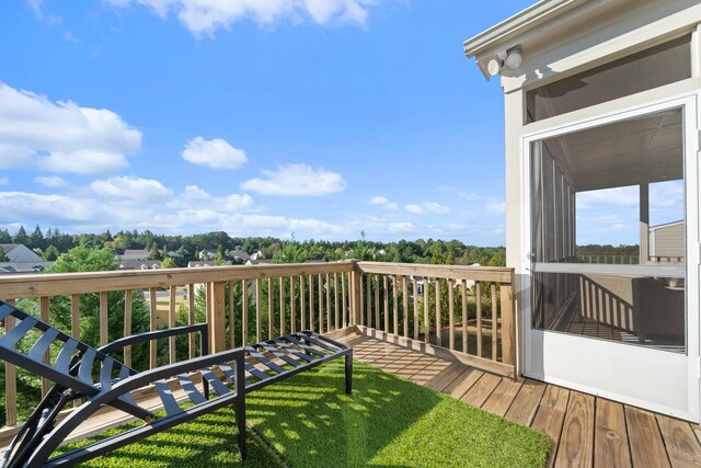 wooden deck with a lawn