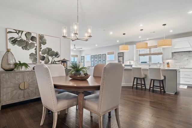 dining area with ceiling fan and dark hardwood / wood-style floors