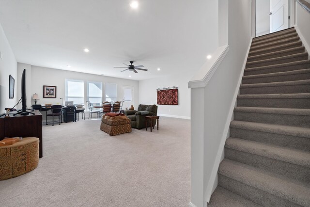 living room featuring ceiling fan and carpet flooring