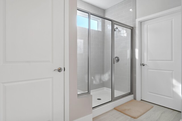 bathroom with a shower with shower door