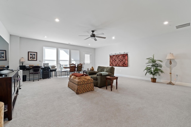 living room with light colored carpet and ceiling fan