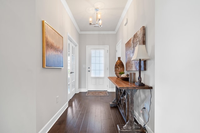 entryway featuring a notable chandelier, crown molding, and dark wood-type flooring