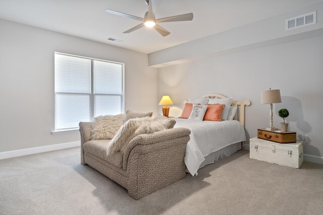 bedroom with ceiling fan and light carpet