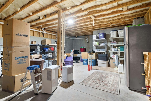 basement with stainless steel refrigerator