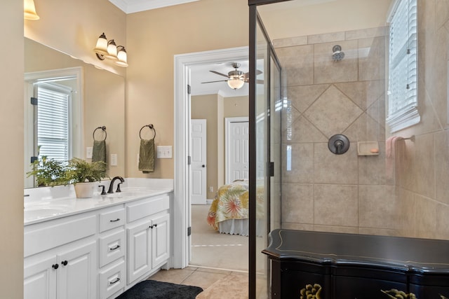 bathroom with ceiling fan, ornamental molding, vanity, and tile patterned floors