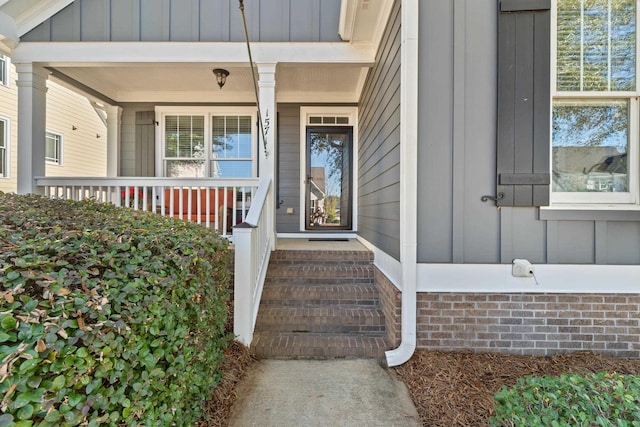 view of exterior entry with a porch