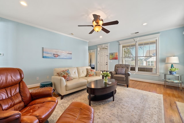 living room with crown molding, ceiling fan, and light wood-type flooring