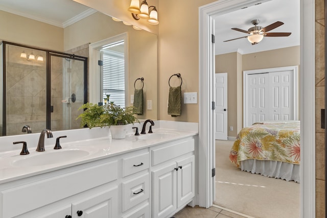 bathroom featuring ornamental molding, vanity, a shower with door, ceiling fan, and tile patterned flooring