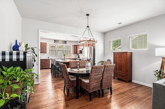 1000 Eight Knot Ct, Greensboro, GA 30642 - dining space with hardwood / wood-style floors, a chandelier, and baseboards