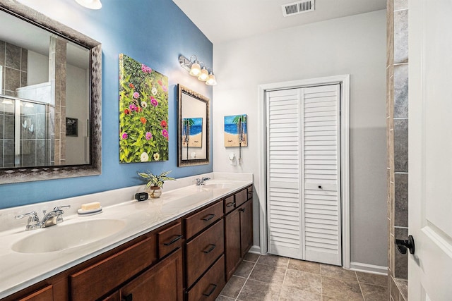 1000 Eight Knot Ct, Greensboro, GA 30642 - bathroom featuring double vanity, tiled shower, baseboards, and a closet
