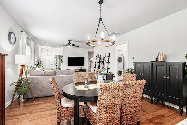 1000 Eight Knot Ct, Greensboro, GA 30642 - dining area with stacked washer / dryer, light wood-type flooring, a ceiling fan, and baseboards
