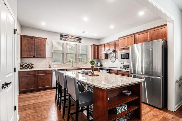 1000 Eight Knot Ct, Greensboro, GA 30642 - kitchen with appliances with stainless steel finishes, a sink, a kitchen island, light stone counters, and open shelves