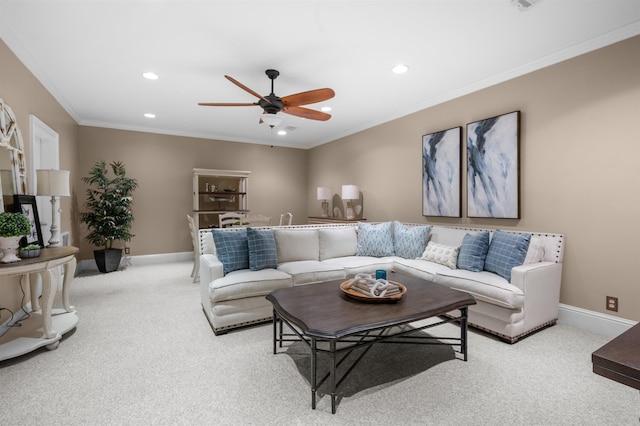 carpeted living room with ceiling fan and ornamental molding