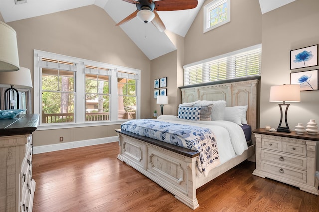 bedroom featuring dark wood-type flooring, high vaulted ceiling, and ceiling fan