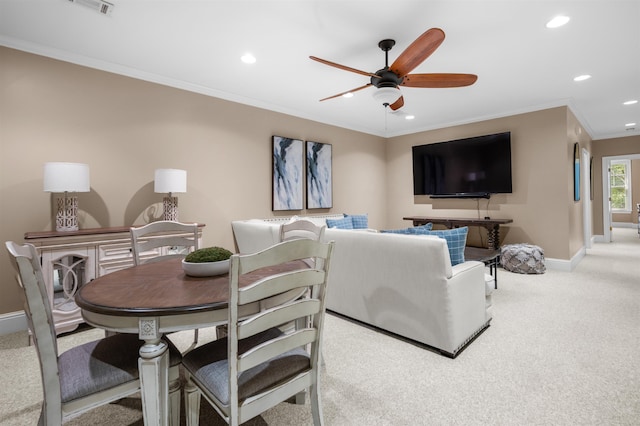 carpeted living room with crown molding and ceiling fan