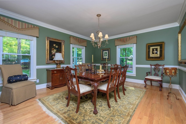 1811 Snug Harbor Dr, Greensboro, GA 30642 - dining space featuring a chandelier, ornamental molding, plenty of natural light, and light wood-style floors