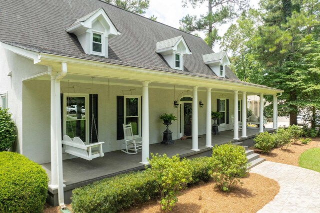 1811 Snug Harbor Dr, Greensboro, GA 30642 - view of front of property featuring covered porch, stucco siding, and a shingled roof