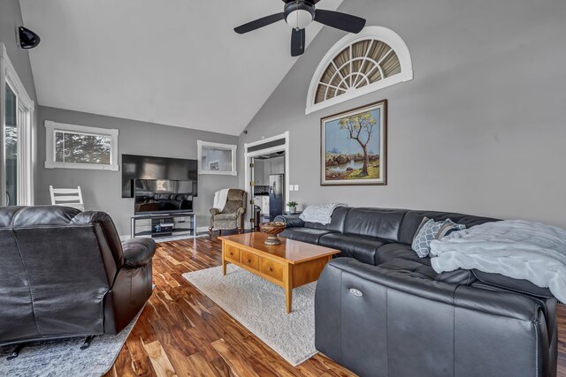 living room featuring ceiling fan, dark hardwood / wood-style floors, and high vaulted ceiling