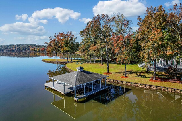 dock area with a water view and a lawn