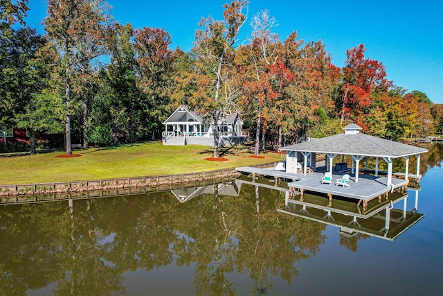 dock area with a water view and a yard