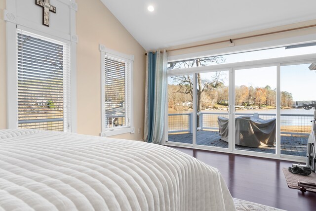 bedroom featuring a water view, vaulted ceiling, hardwood / wood-style floors, and access to outside