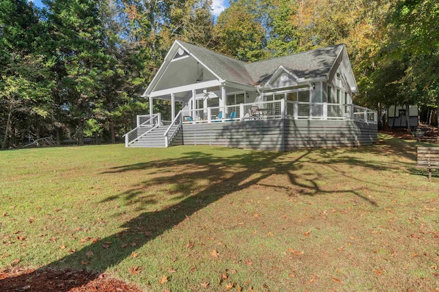 rear view of house with a yard and ceiling fan