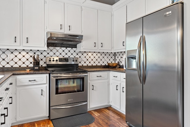 kitchen with white cabinetry, decorative backsplash, appliances with stainless steel finishes, and light hardwood / wood-style flooring