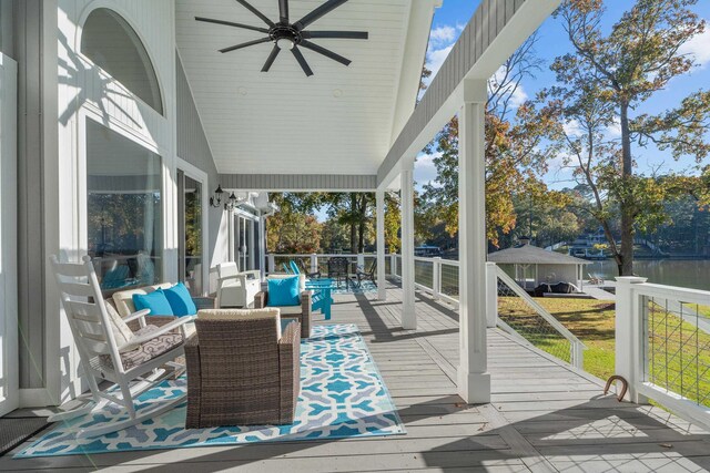 sunroom featuring a water view, a healthy amount of sunlight, lofted ceiling, and ceiling fan