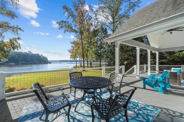 view of patio / terrace featuring a deck with water view and ceiling fan