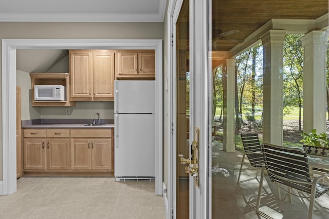 kitchen with crown molding, white appliances, and sink