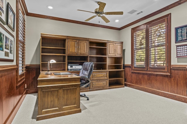 carpeted office space featuring crown molding, ceiling fan, and wooden walls