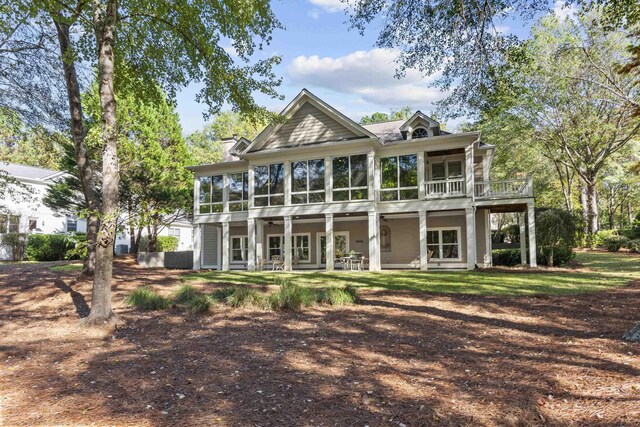 back of property with a sunroom