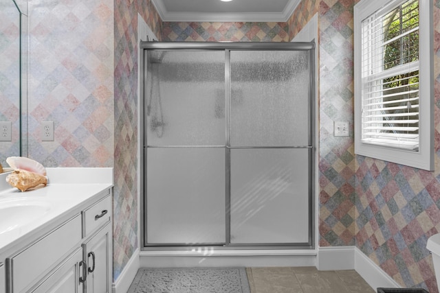 bathroom with a shower with shower door, ornamental molding, vanity, toilet, and tile patterned floors