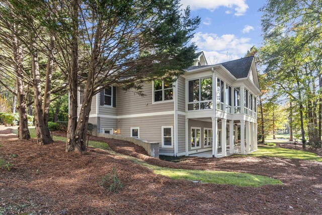 view of property exterior featuring a sunroom