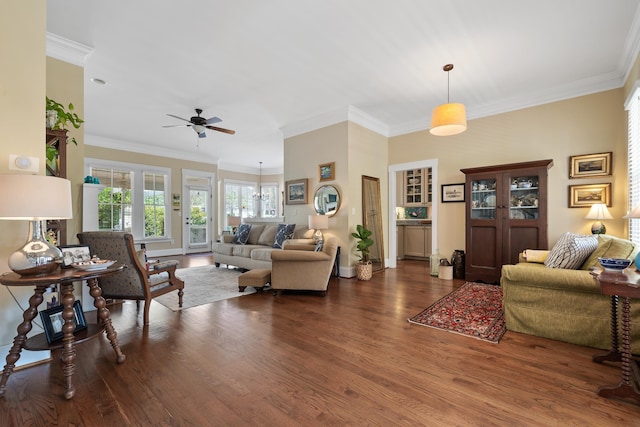 living room featuring crown molding, ceiling fan, wood finished floors, and baseboards