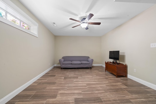 sitting room featuring visible vents, baseboards, wood finished floors, and ceiling fan