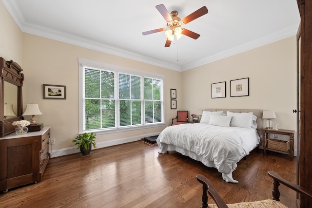 bedroom featuring a ceiling fan, wood finished floors, baseboards, and ornamental molding