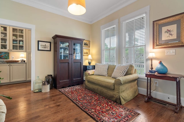living room with crown molding, wood finished floors, and baseboards