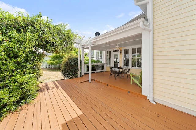 wooden terrace with a pergola, outdoor dining area, and fence