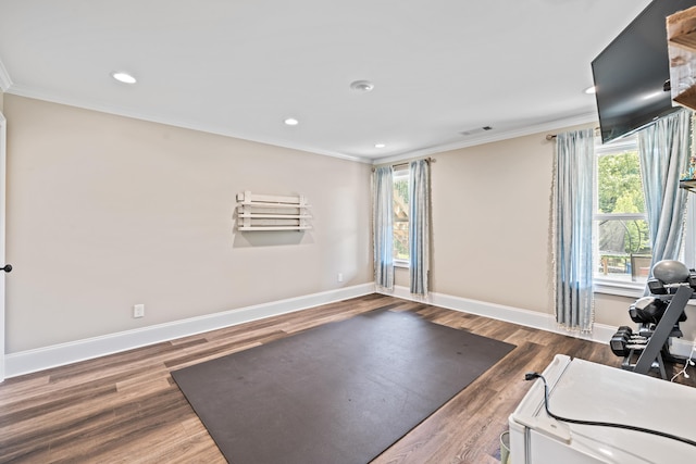 workout area with crown molding and dark hardwood / wood-style floors