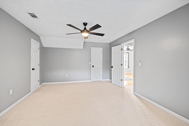 carpeted empty room featuring a textured ceiling and ceiling fan