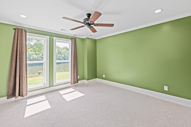 unfurnished room with ornamental molding, light carpet, and ceiling fan