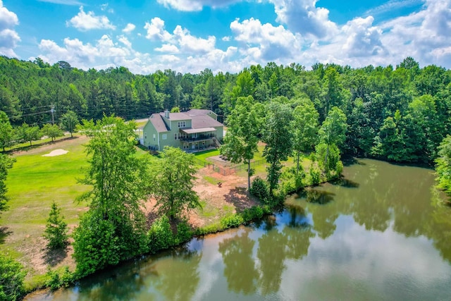 drone / aerial view with a water view and a forest view