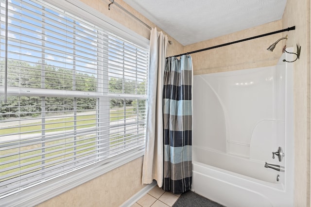 bathroom with shower / tub combo with curtain, tile patterned floors, and a textured ceiling