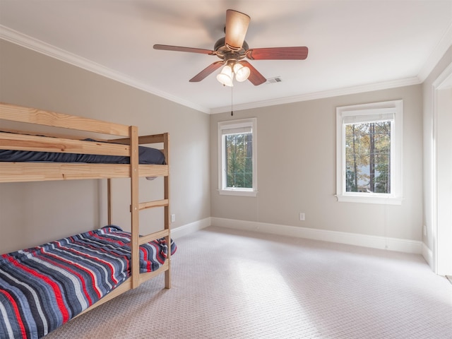 bedroom featuring crown molding, ceiling fan, and carpet